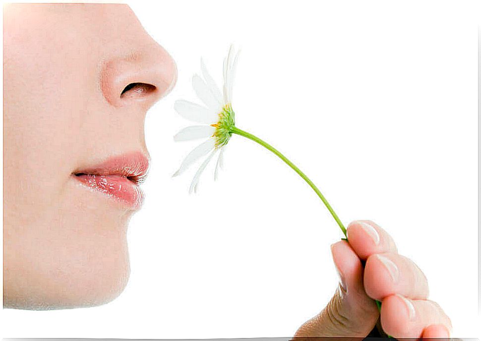 A woman smelling a flower