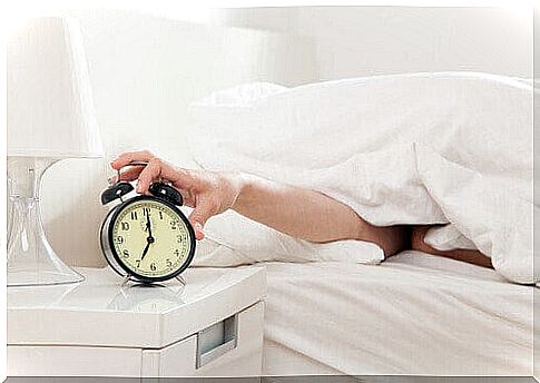 Woman turns off alarm clock