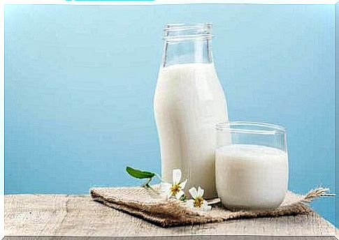 Milk in a glass bottle and a glass