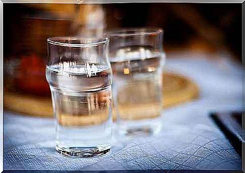 Two glasses of water standing on a table.