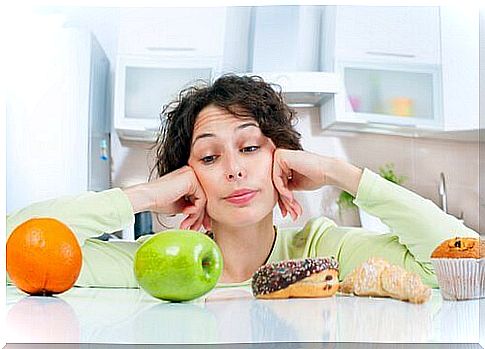 Woman looking at healthy and unhealthy foods