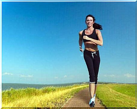 A woman running near the sea.