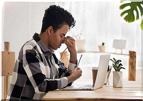 A person who experiences visual fatigue while working on a laptop.