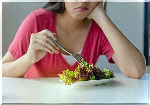 A woman eating a salad.