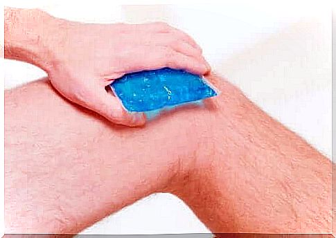 A person who applies ice to the knee to relieve pain.