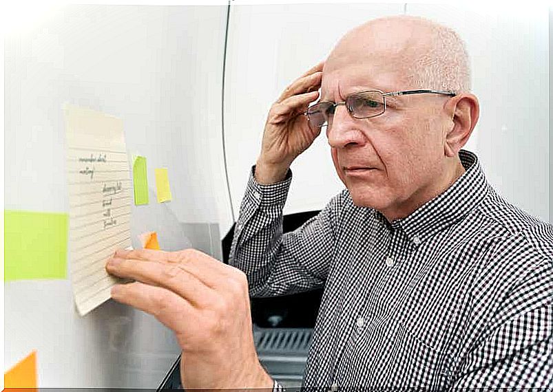 An elderly man with amnesia looks at a list.