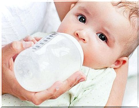 Baby drinks from bottle