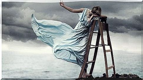 Woman in ladder by the sea