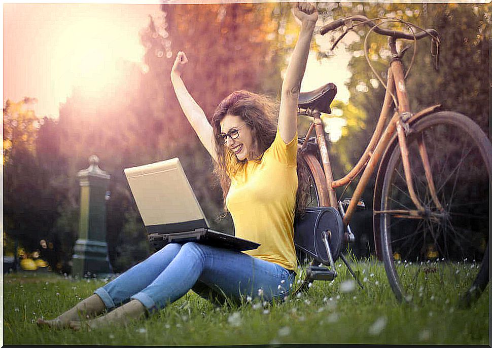 Woman with bicycle and PC in the park