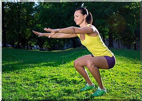 A woman doing squats in a park